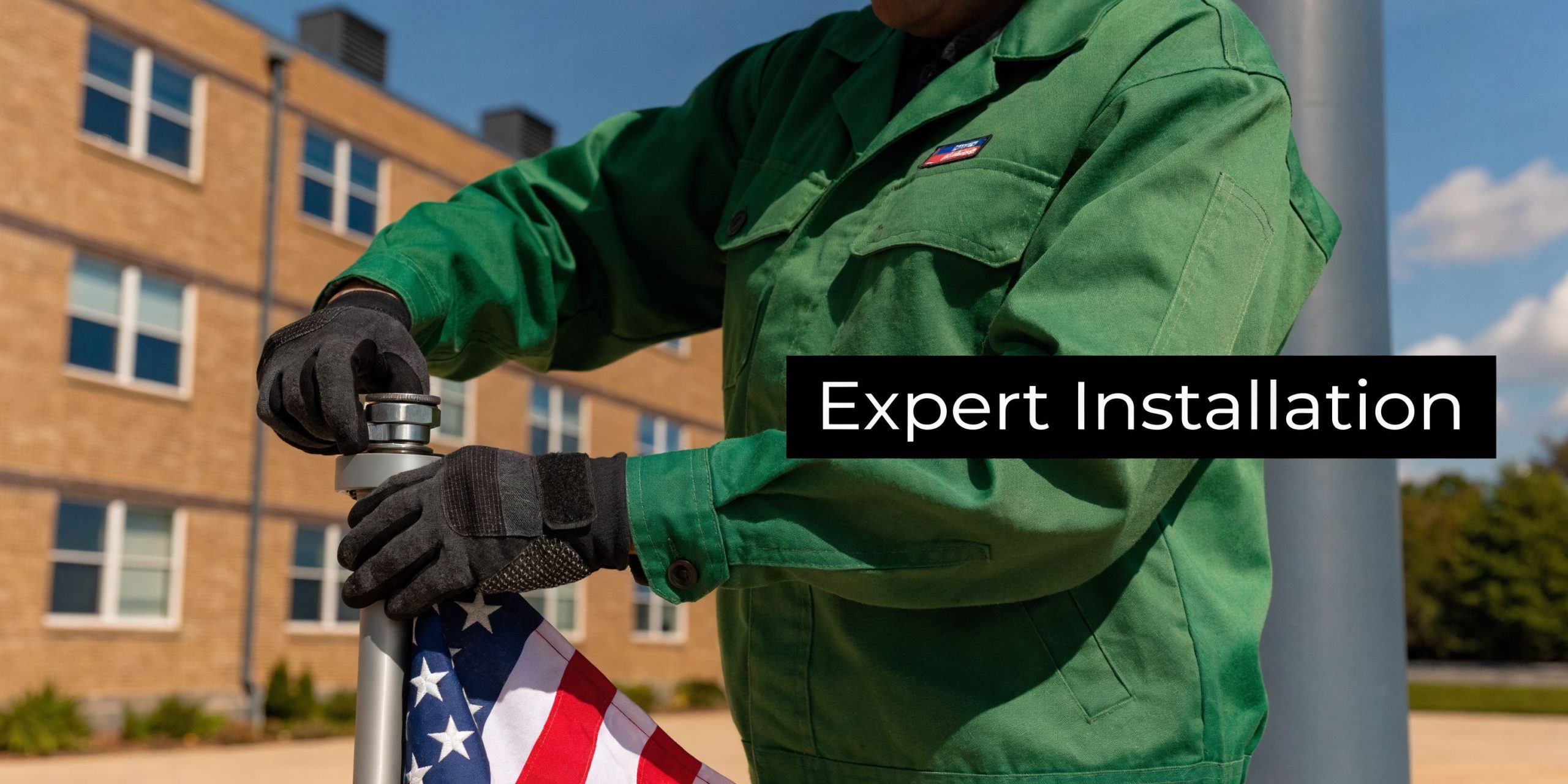 A technician wearing work gloves professionally installing an American flag on a flagpole outdoors in Tucson.